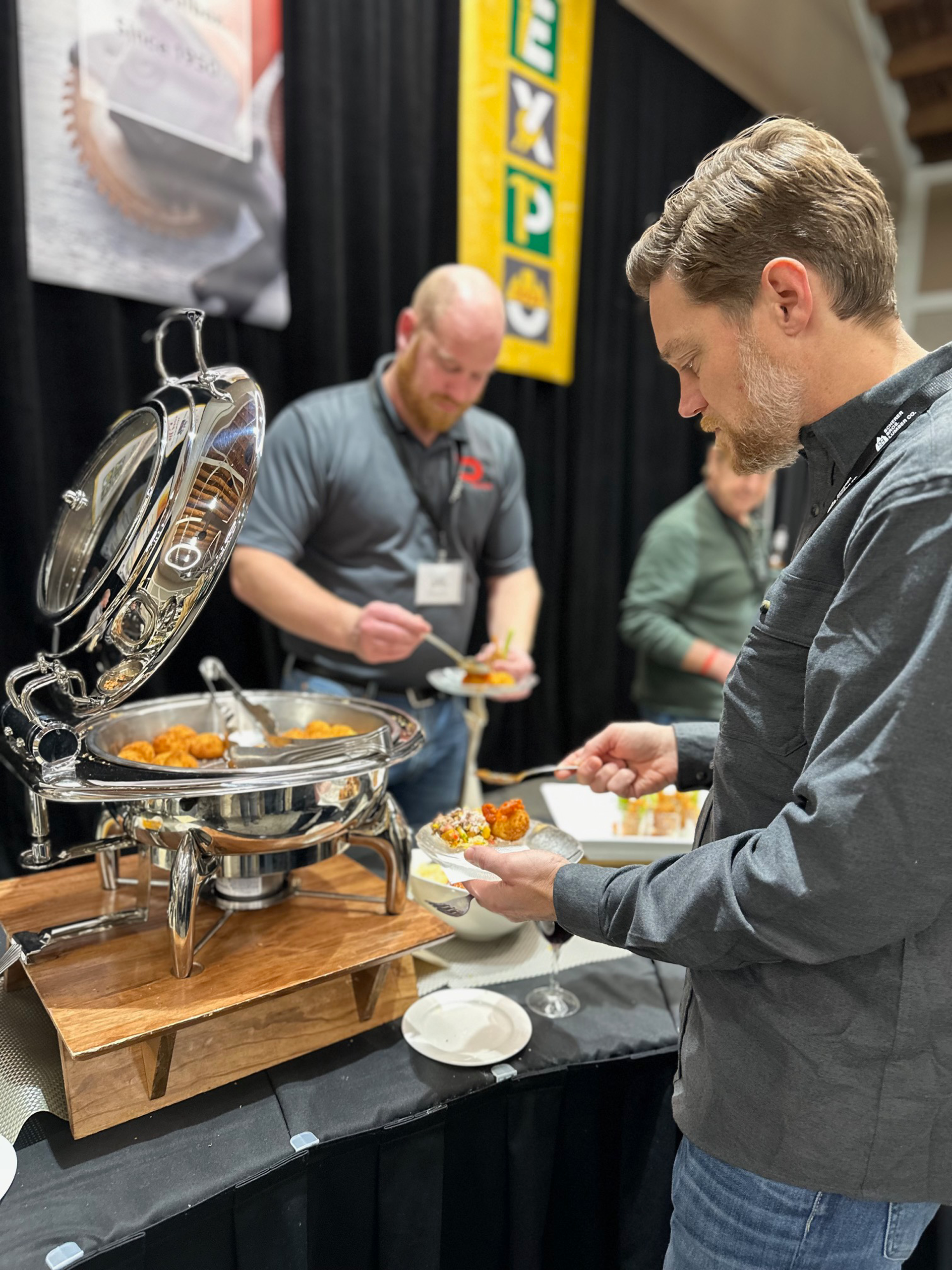 People dishing up food at an expo